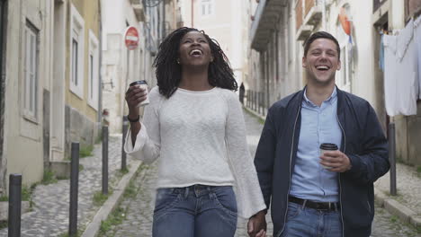 Happy-multiracial-couple-strolling-on-street.