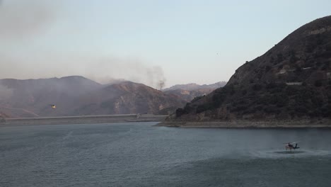 helicopter refilling water drop after a brushfire holser fire burns a hillside near lake piru california 5