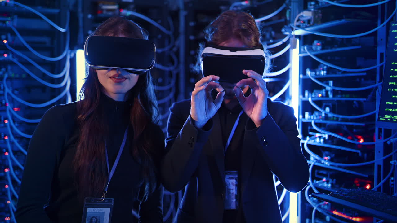 A man and a woman using Virtual Reality headsets in a server room