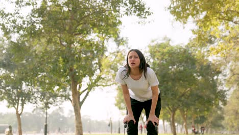 indian girl gets tired after skipping rope in a park in morning