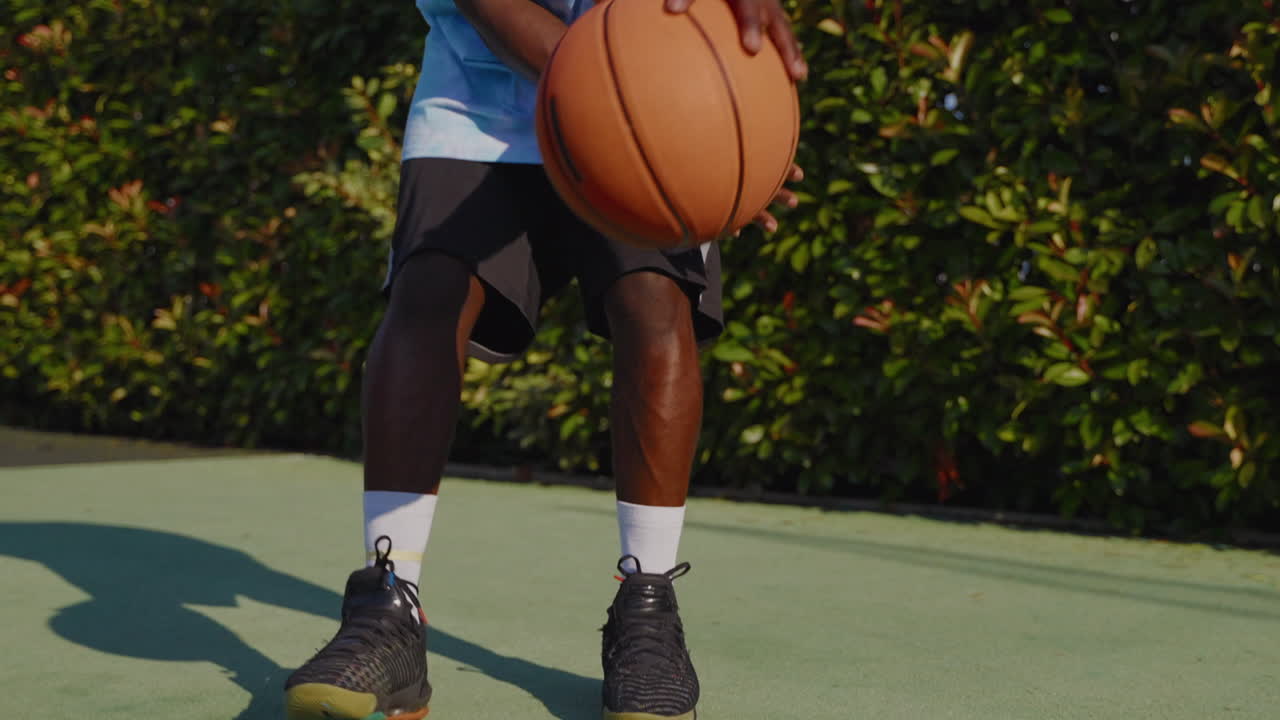 Man Playing Basketball on Outdoor Court