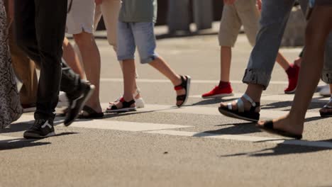 the feet of people at the crosswalk.