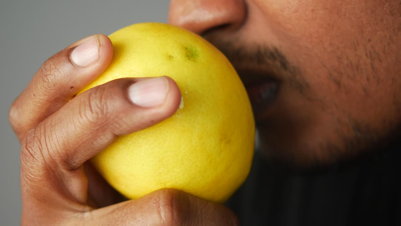 Person smelling a lemon