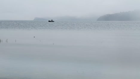 a fisherman in a boat on lake baikal