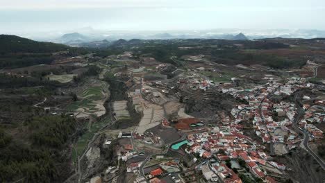 Aerial-Forwarding-Dolly-of-Beautiful-Mountainside-Village-Alongside-Forest-in-Spain