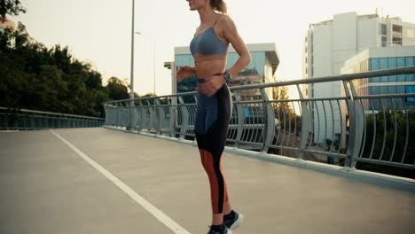 close-up shot of a young girl in sportswear running in place and warming up before running in the morning. morning run healthy lifestyle