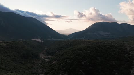 dark shadow mountain range and gorge during sunset, reveal of old parked cars