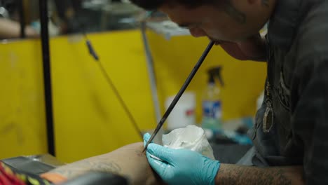 tattoo artist working on body art