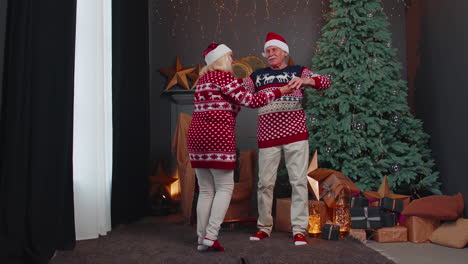 elderly family couple grandmother grandmother dancing at decorated home room with christmas tree