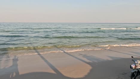 a serene beach walk interrupted by a motorbike