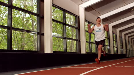 fit man running on the indoor track