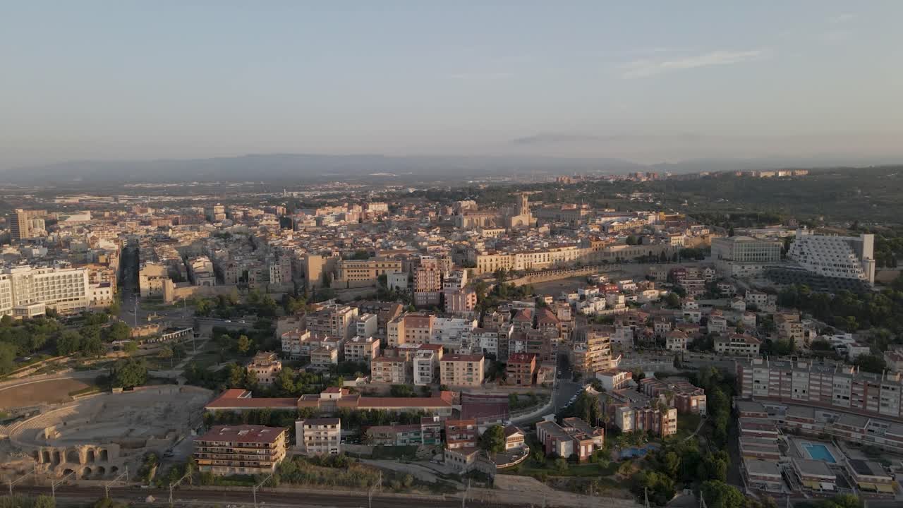 A captivating circular drone shot within Tarragona, Spain, revealing half of the city alongside the iconic Tarragona Cathedral