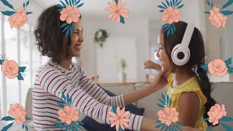 Animation-of-pink-flowers-over-smiling-biracial-mother-dancing-with-daughter-wearing-headphones