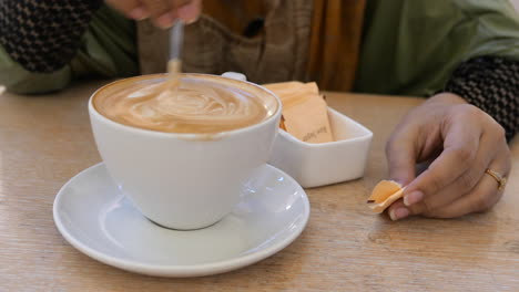 woman enjoying a latte at a cafe