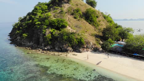 Pulau-Kelor-island-in-Indonesia-at-Komodo-national-Park,-shot-from-ascending-vertically-drone,-offering-a-stunning-aerial-perspective-of-the-island's-beauty-and-surroundings