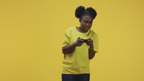 young black woman intensely playing video games with a controller