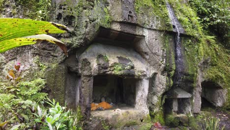 Ancient-Cave-Archaeological-Stone-at-Goa-Garba,-Bali,-Indonesia,-Balinese-Site-of-Praying-and-Worship,-Moss-on-Carved-Architecture-on-Sacred-Place-from-12th-Century