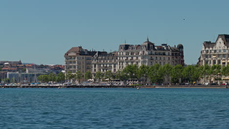 peaceful morning in geneva with the iconic jet d’eau rising from the lake, calm waters reflecting the clear sky, and the city slowly coming to life in the morning light.