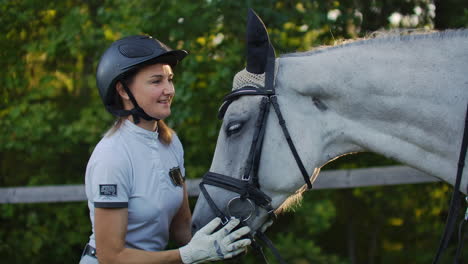 Horsewomen-is-stroking-her-horse.-She-gives-love-to-horse.-It's-enjoyable-moment-with-her-lovely-friend.