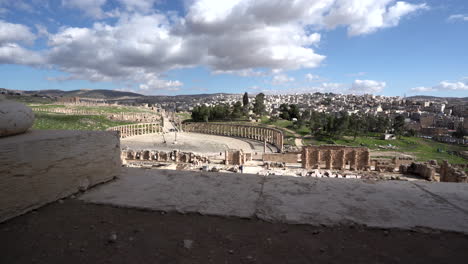 panoramic view of roman ruins in jerash with massive clouds floating in the sunny sky