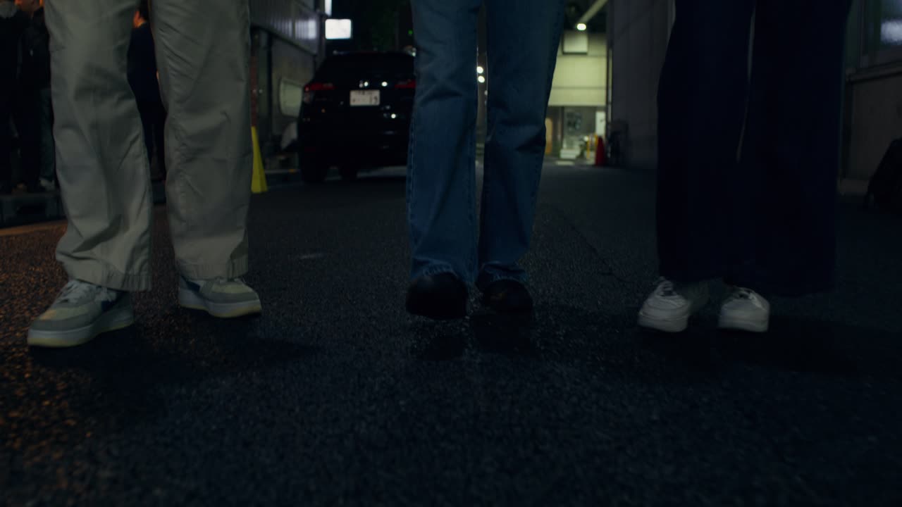 Group of Friends Walking at Night in a City Street