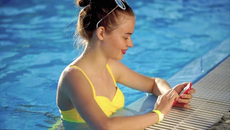 teenage girl relaxing by the pool