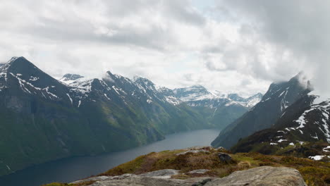 norwegian fjord with dramatic clouds surrounding mountain peaks at the west coast of norway at sunnmøre, liavarden
