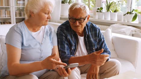 worried senior couple calculating bills