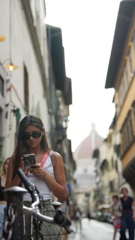 woman using phone in florence, italy