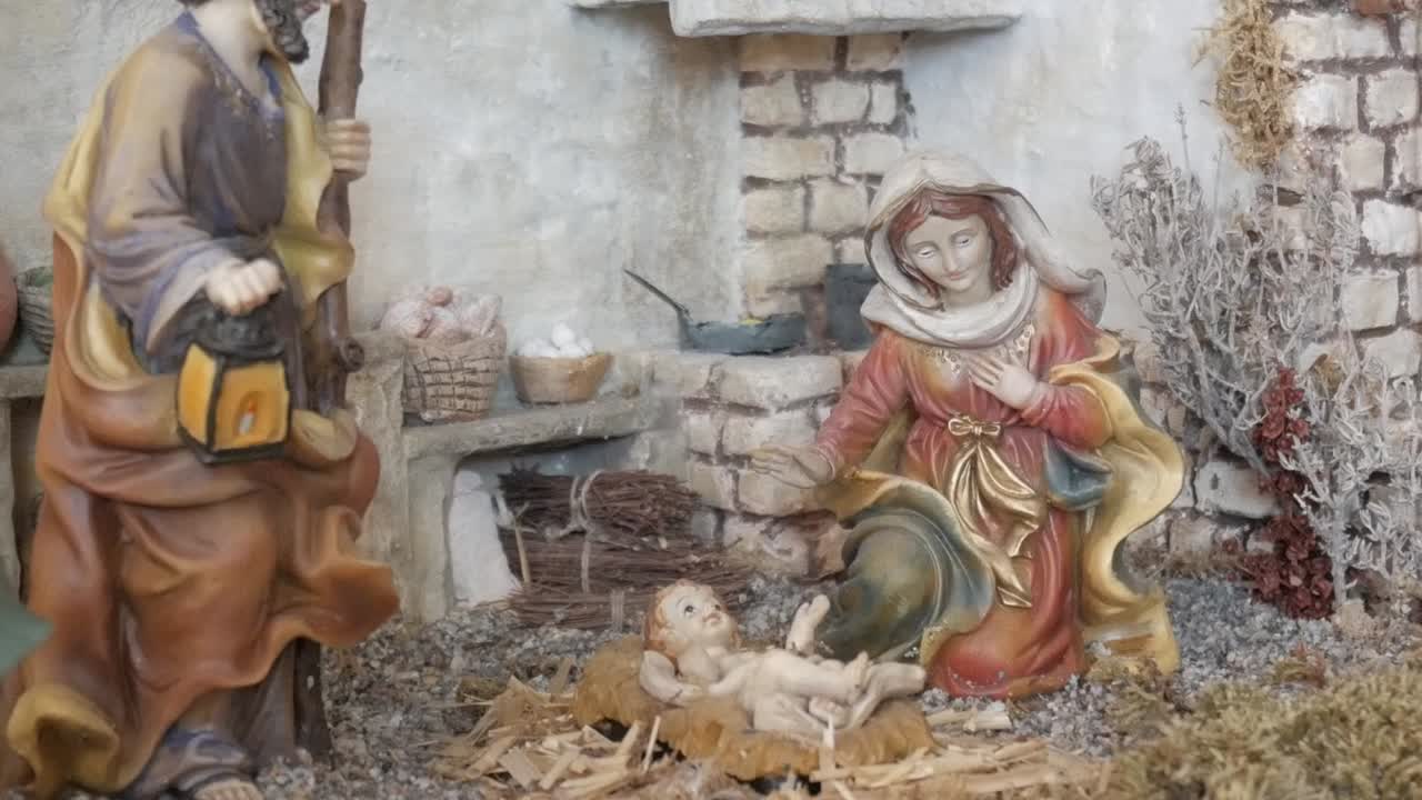 A serene nativity scene featuring Mary, baby Jesus, and a rustic backdrop
