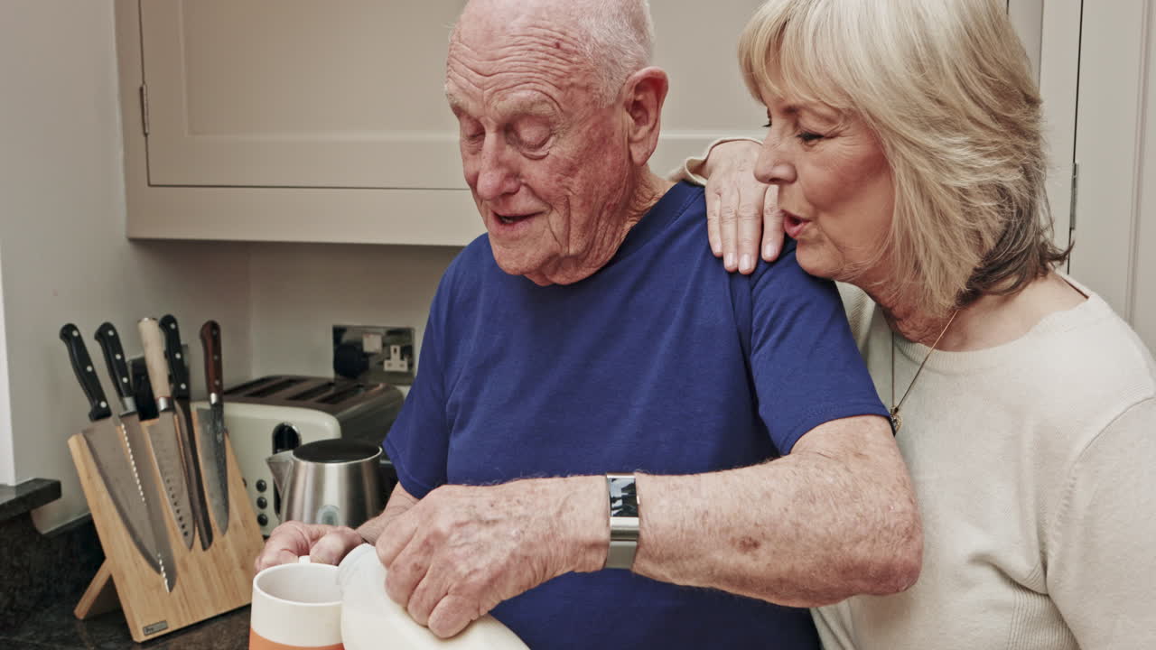 Elderly couple enjoying a moment together in the kitchen