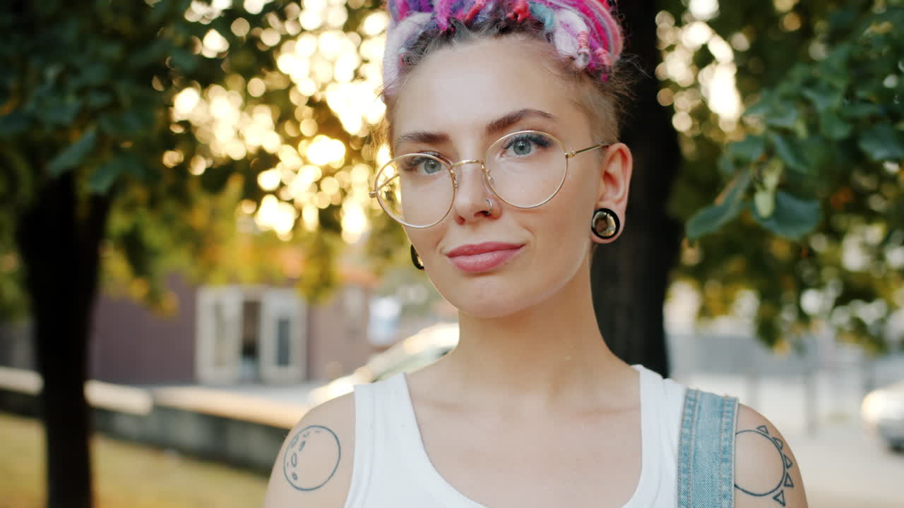 Young Woman with Colorful Dreadlocks and Glasses