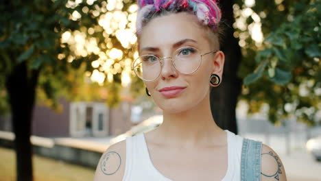 young woman with colorful dreadlocks and glasses