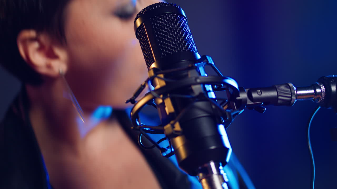 Close-up of a Woman Singing into a Microphone