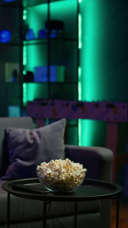 vertical video close up of popcorn bowl in apartment with relaxing atmosphere