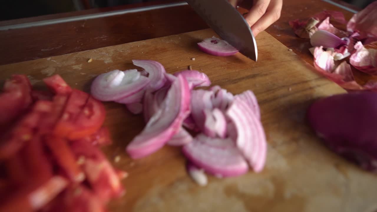Woman hand Using Knife And Cutting Onion On Wooden Cutting Board