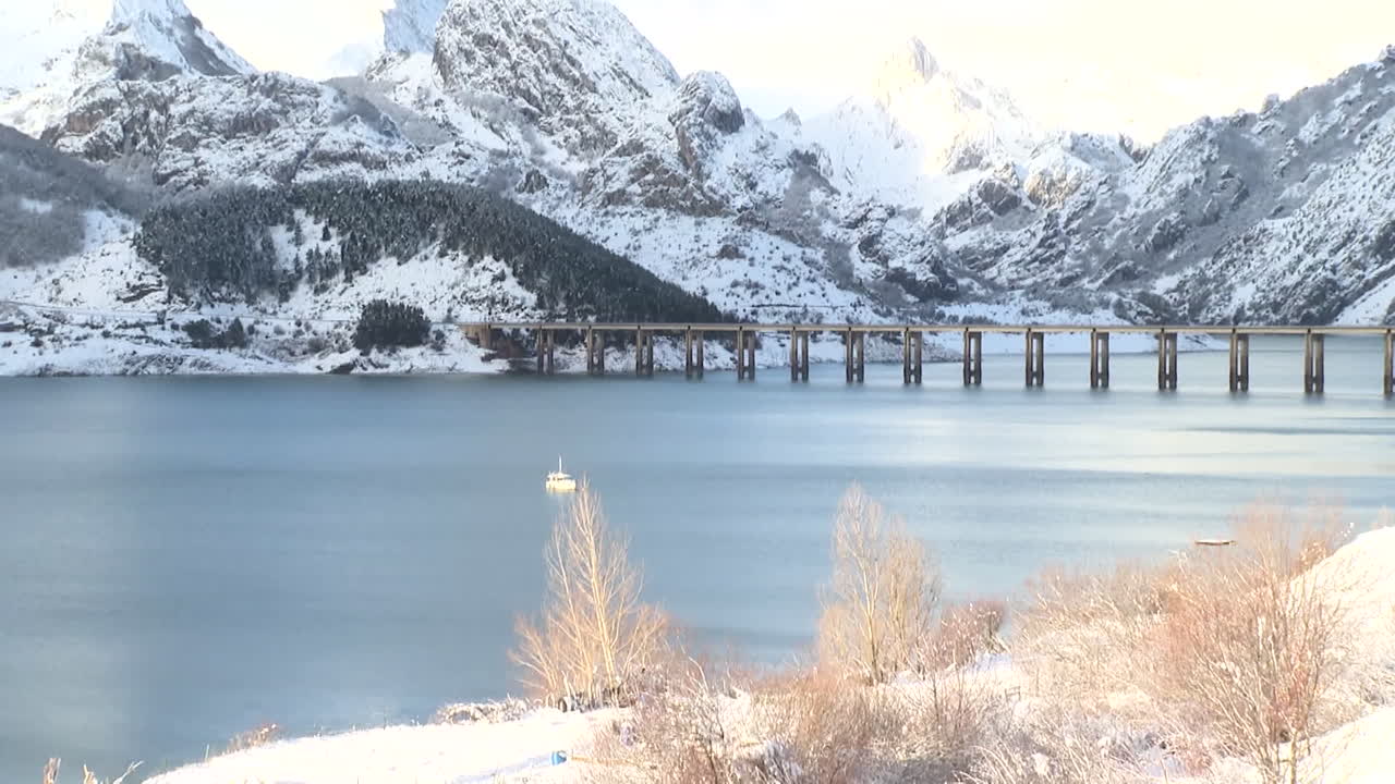 Snowy Mountains and Lake with Bridge