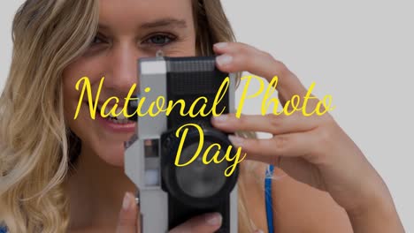 animation of happy caucasian woman holding camera over national photo day text