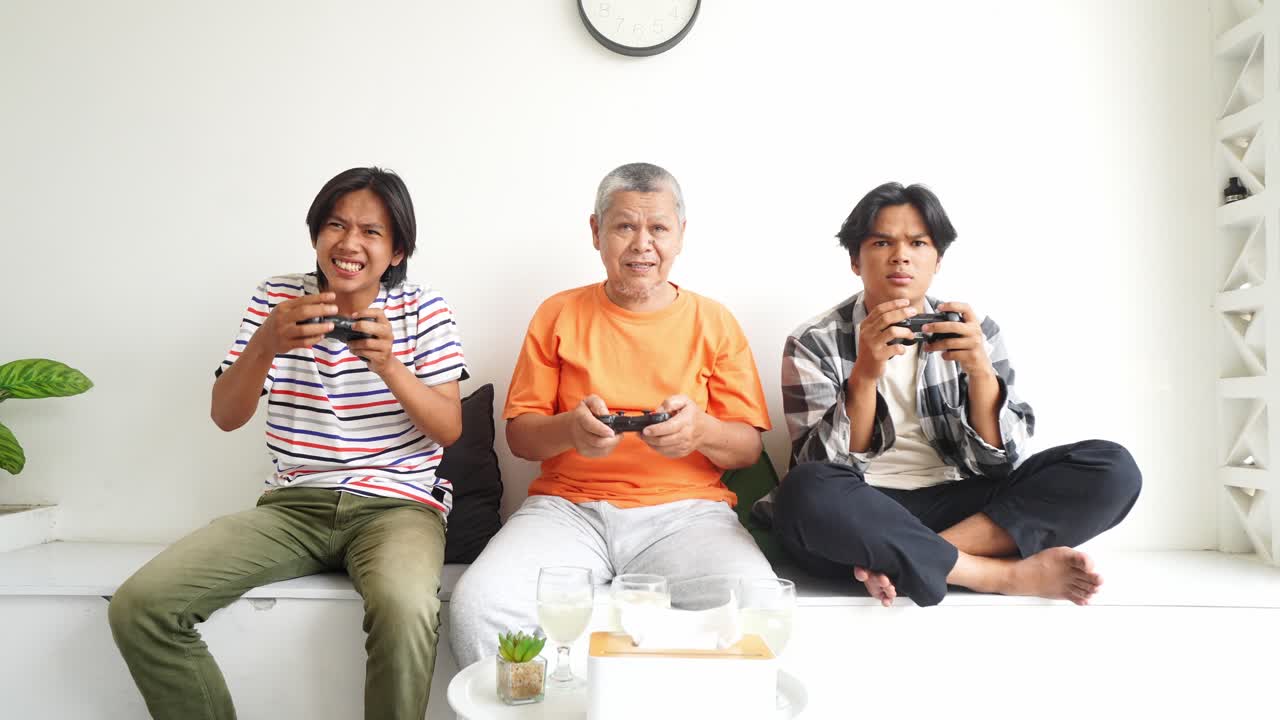 Upset Asian Father and Son Lose Game While Playing Video Games At Home