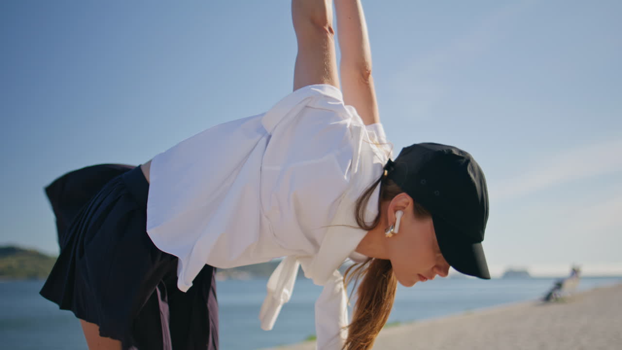 athlete exercising street wearing earbud closeup. Sportswoman bending