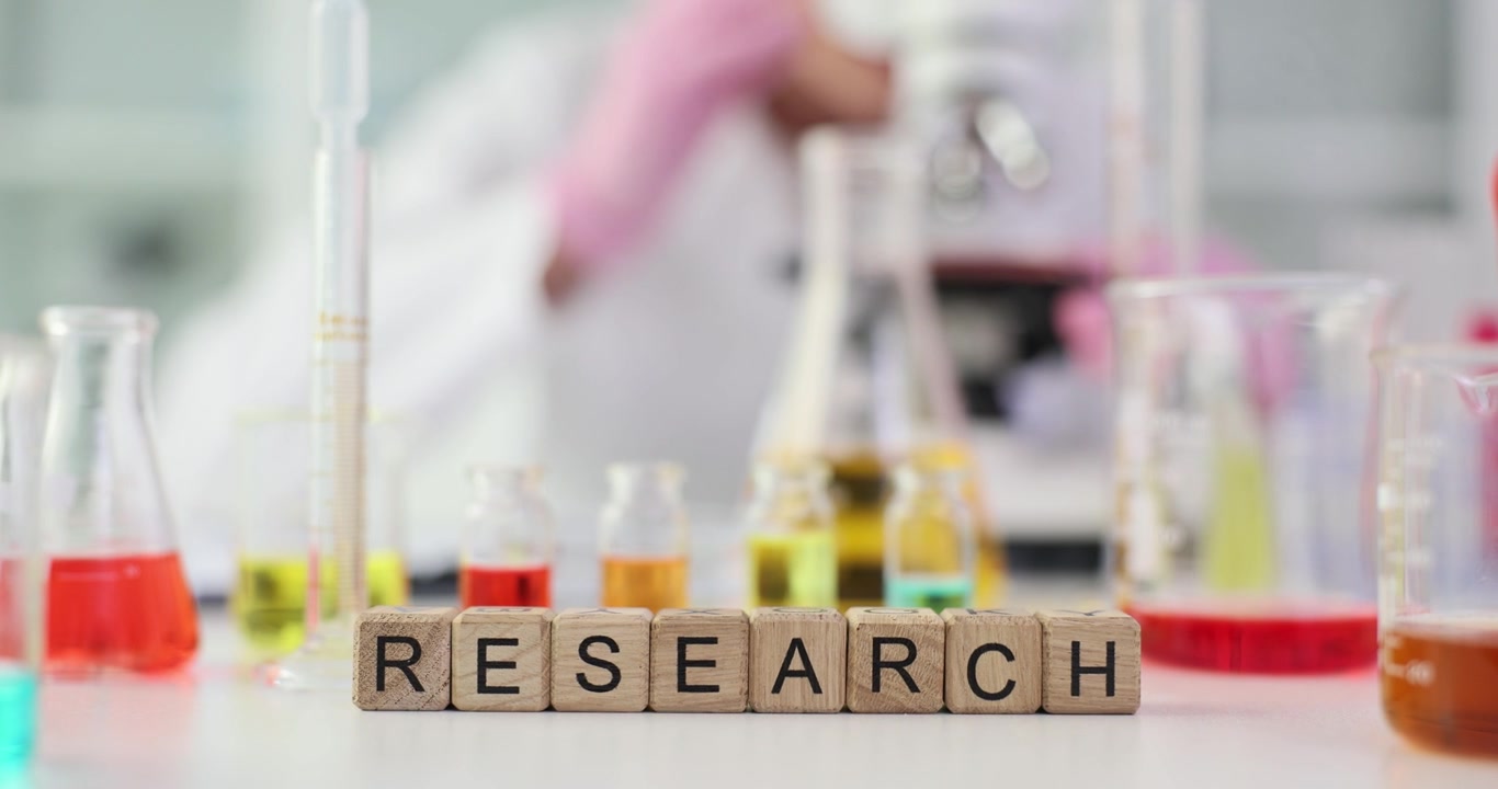 Text research of wooden cubes at scientific workspace