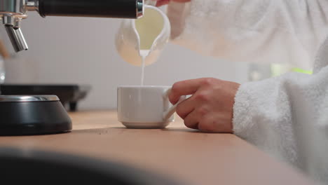 making coffee in a white robe