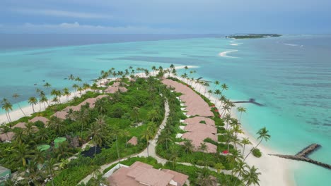 idyllic island resort with white sand beach in maldives. aerial forward, copy space