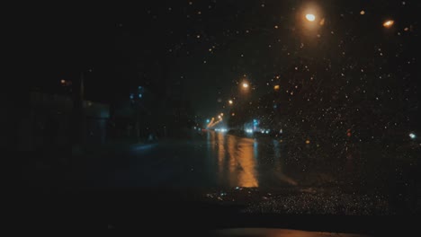 pov through windshield of car at rainy night