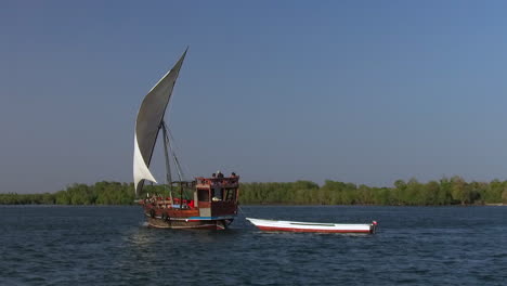a swahili dhow boat sails on mida creek in watamu, kenya.