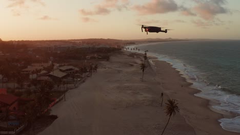 Drone-flying-during-sunset-at-Cumbuco,-Brazil