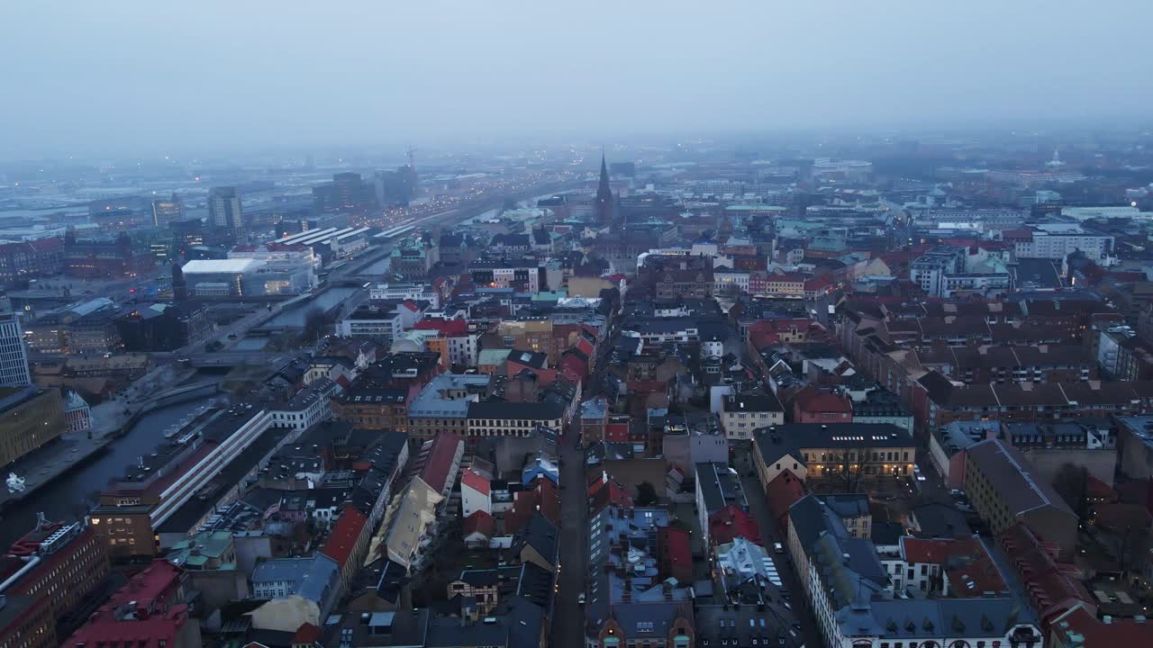 Beautiful aerial dolly of Malmö city skyline on a foggy morning in Sweden