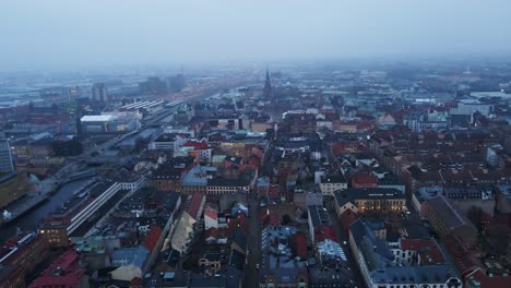 beautiful aerial dolly of malmö city skyline on a foggy morning in sweden