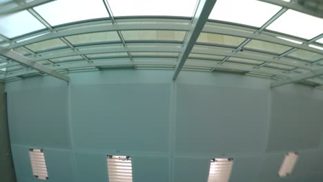 underwater looking up at swimming pool ceiling through ripples in water