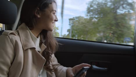 Female Stylish beautiful Lady Entrepreneur in taxi uber cab car talking and consulting on phone business going to work in a traffic jam